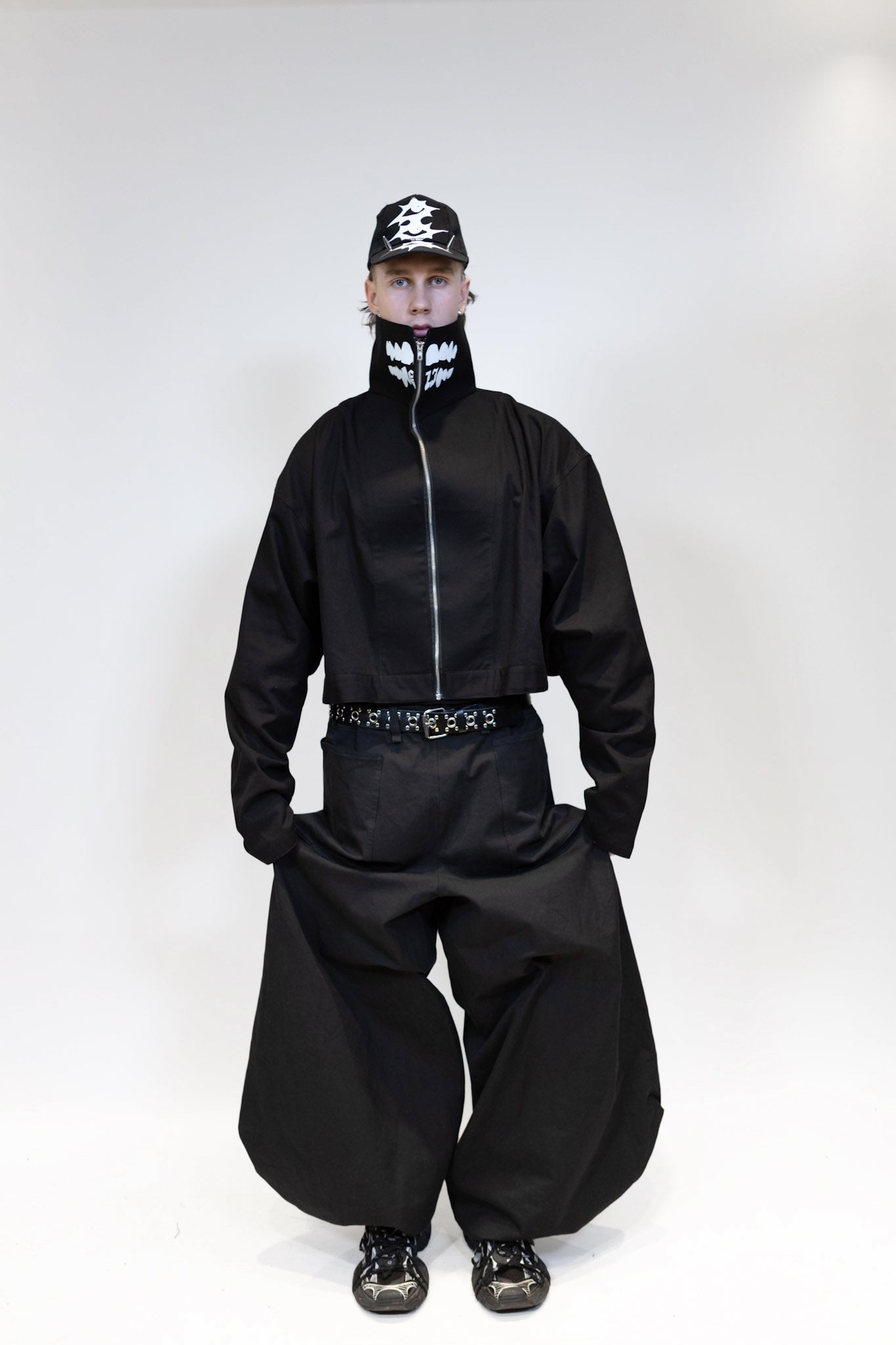 fullbody picture of a male model wearing eli nikkabokka pants and eli windshield jacket from the front