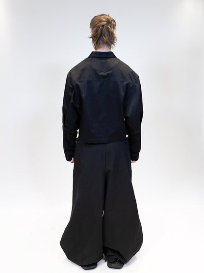 fullbody picture of a male model wearing eli ninja jacket with nikkabokka pants from the back