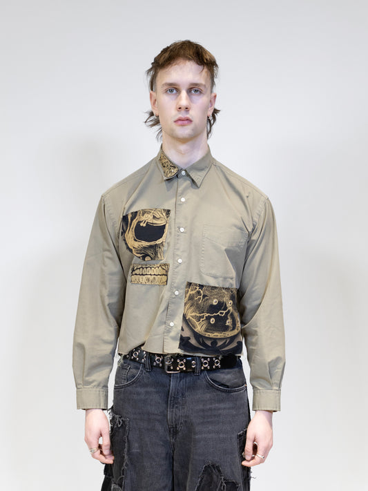 A model wearing a beige shirt with patched, picture from front