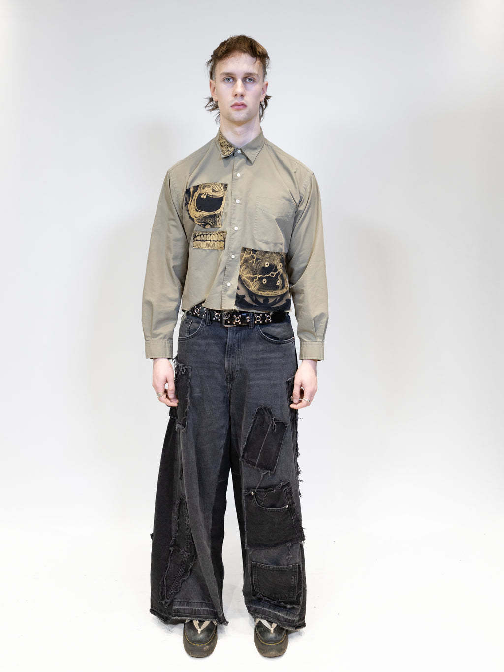 A male model wearing tan shirt with jeans