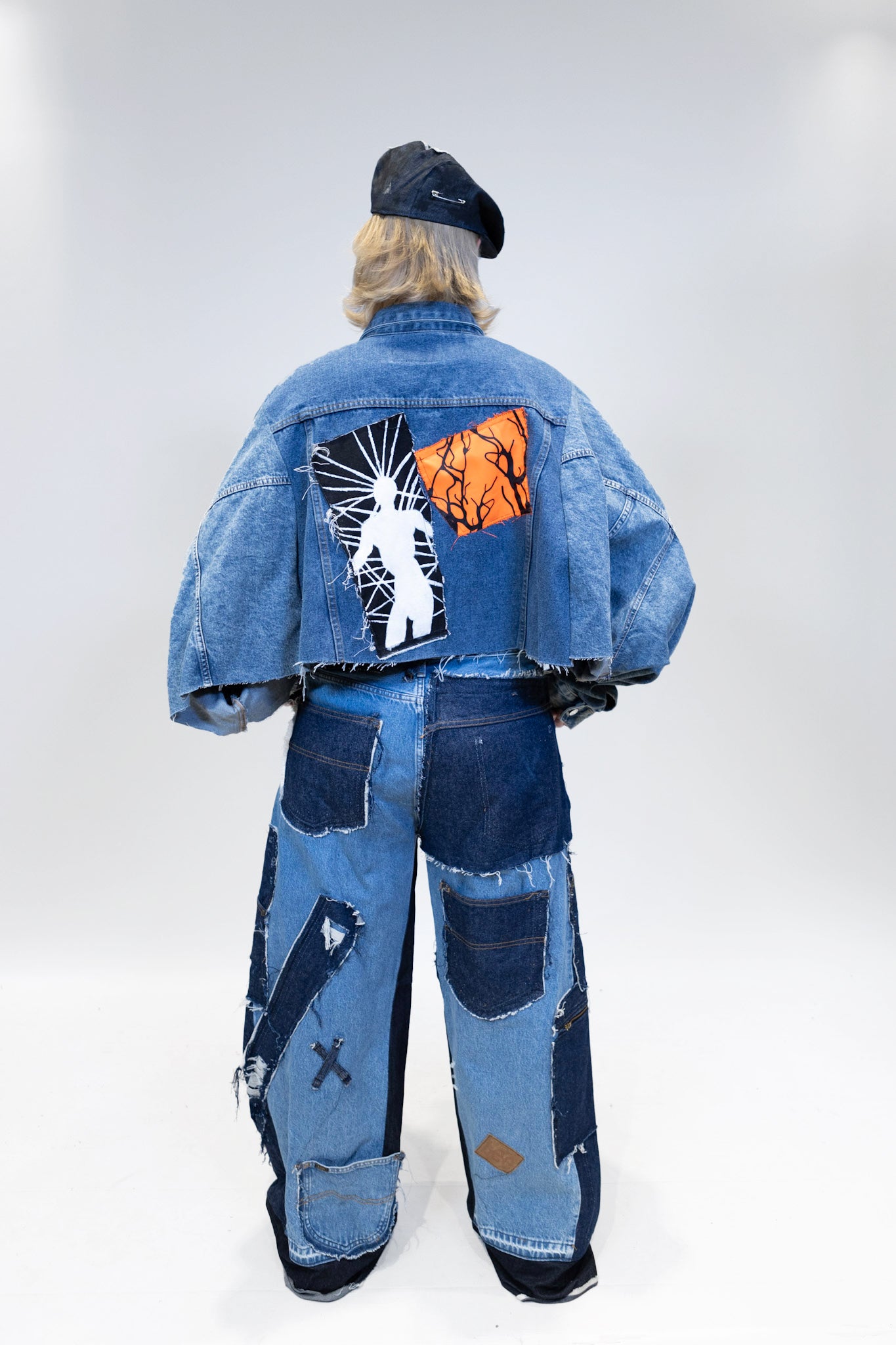 female model wearing full patches outfit from the back full body picture