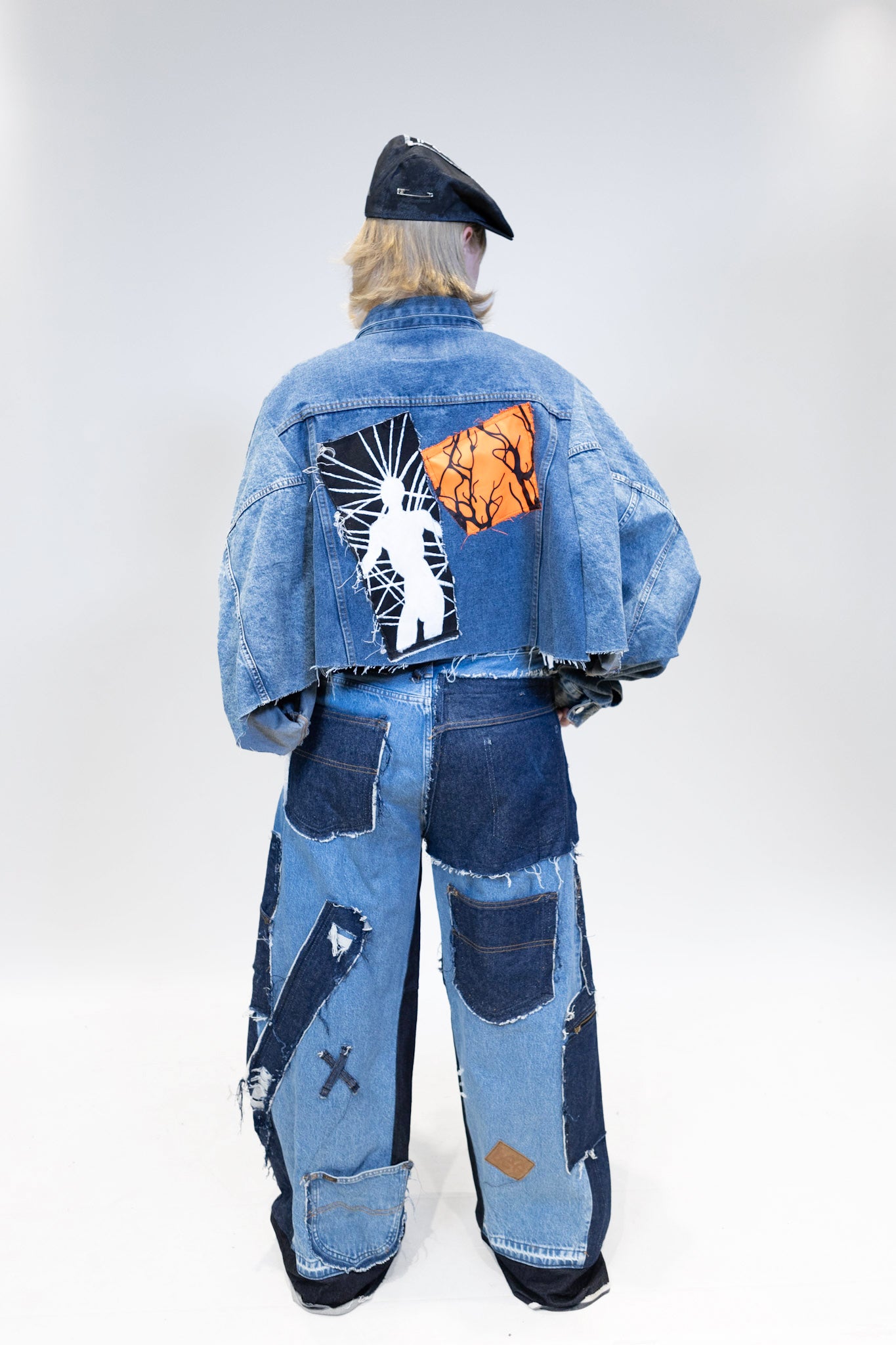 female model wearing full patches outfit, picture from the back full picture